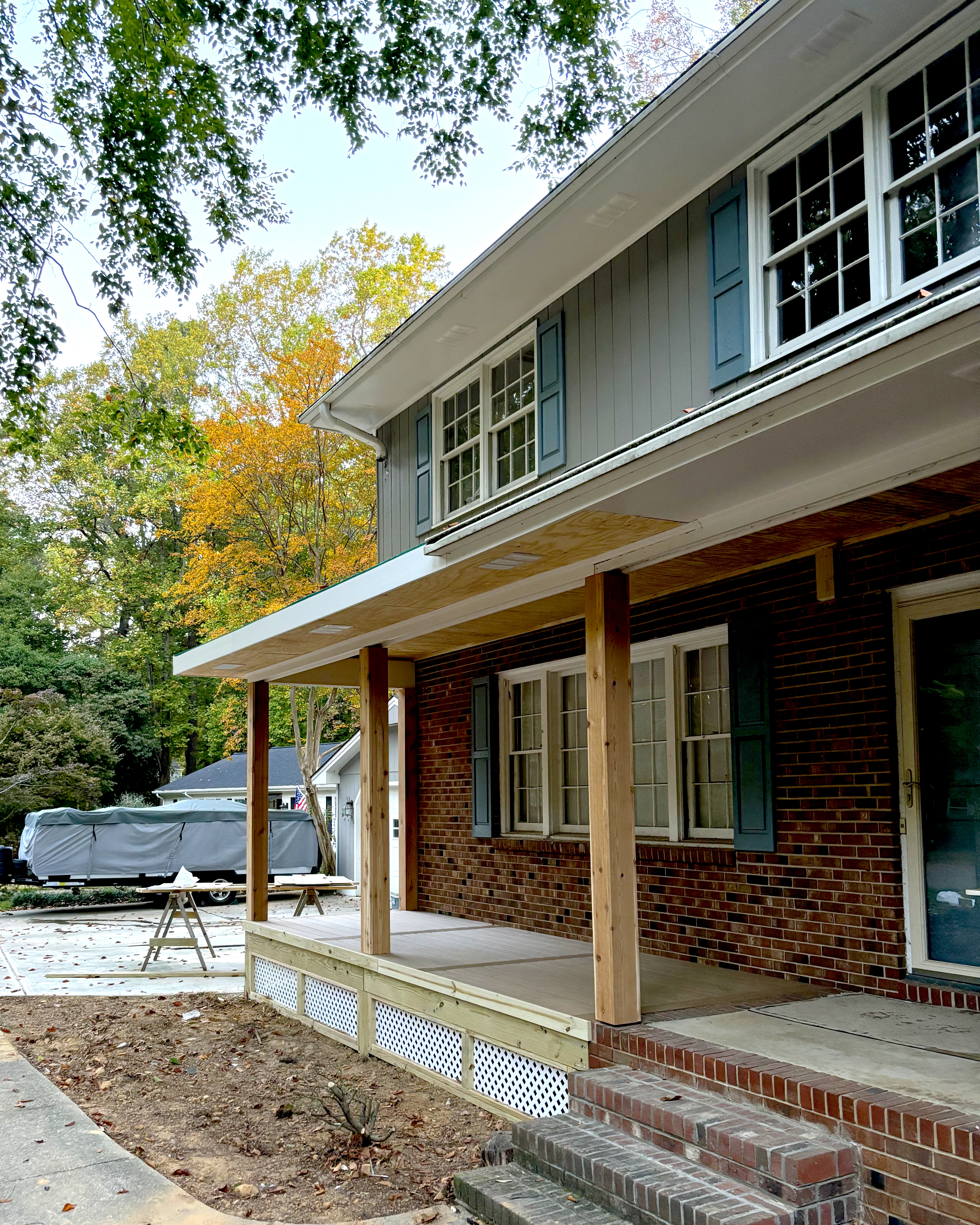Front porch framing with new posts, beams, and structural supports.