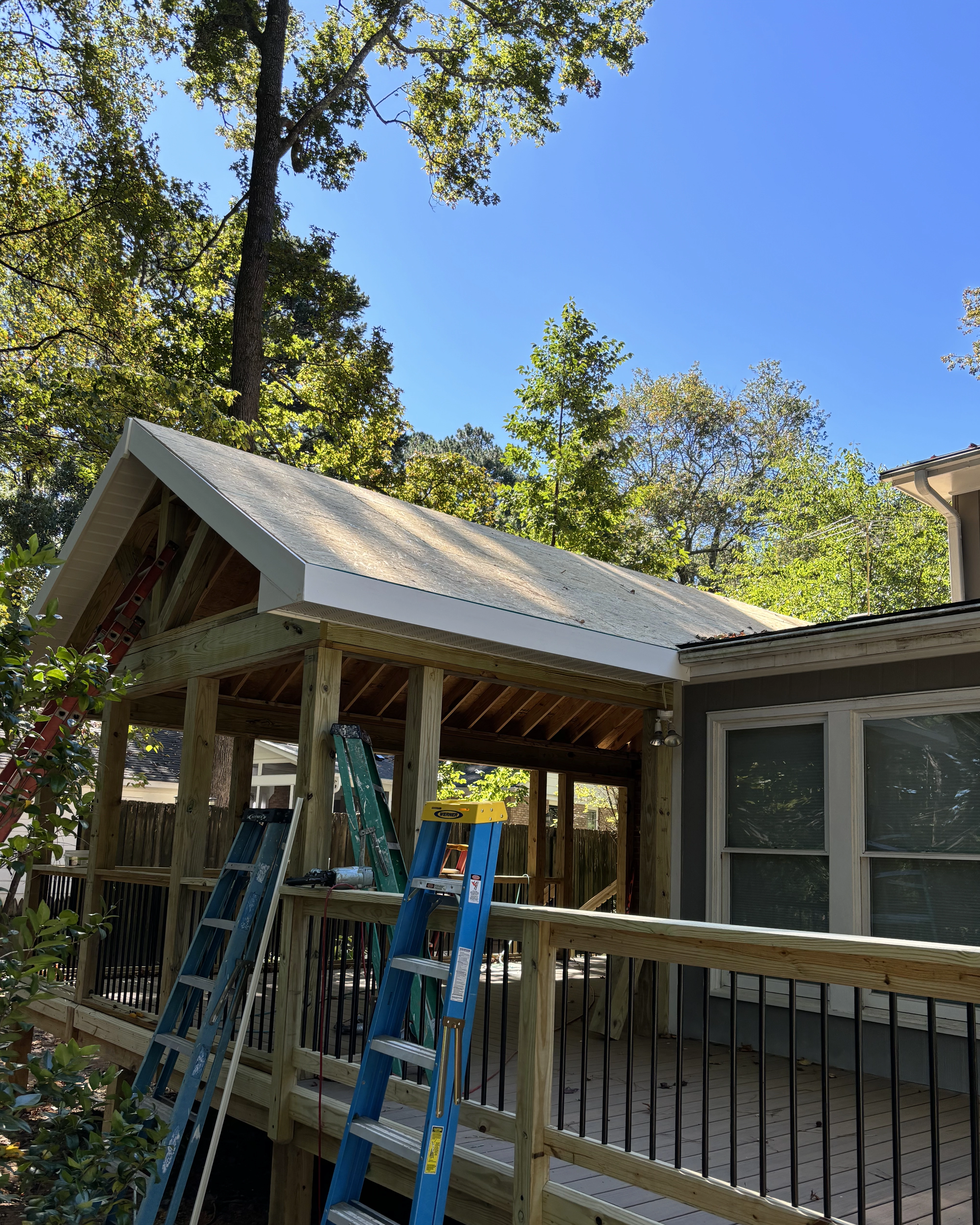 Full screened-porch framing with posts, beams, and railing sections.