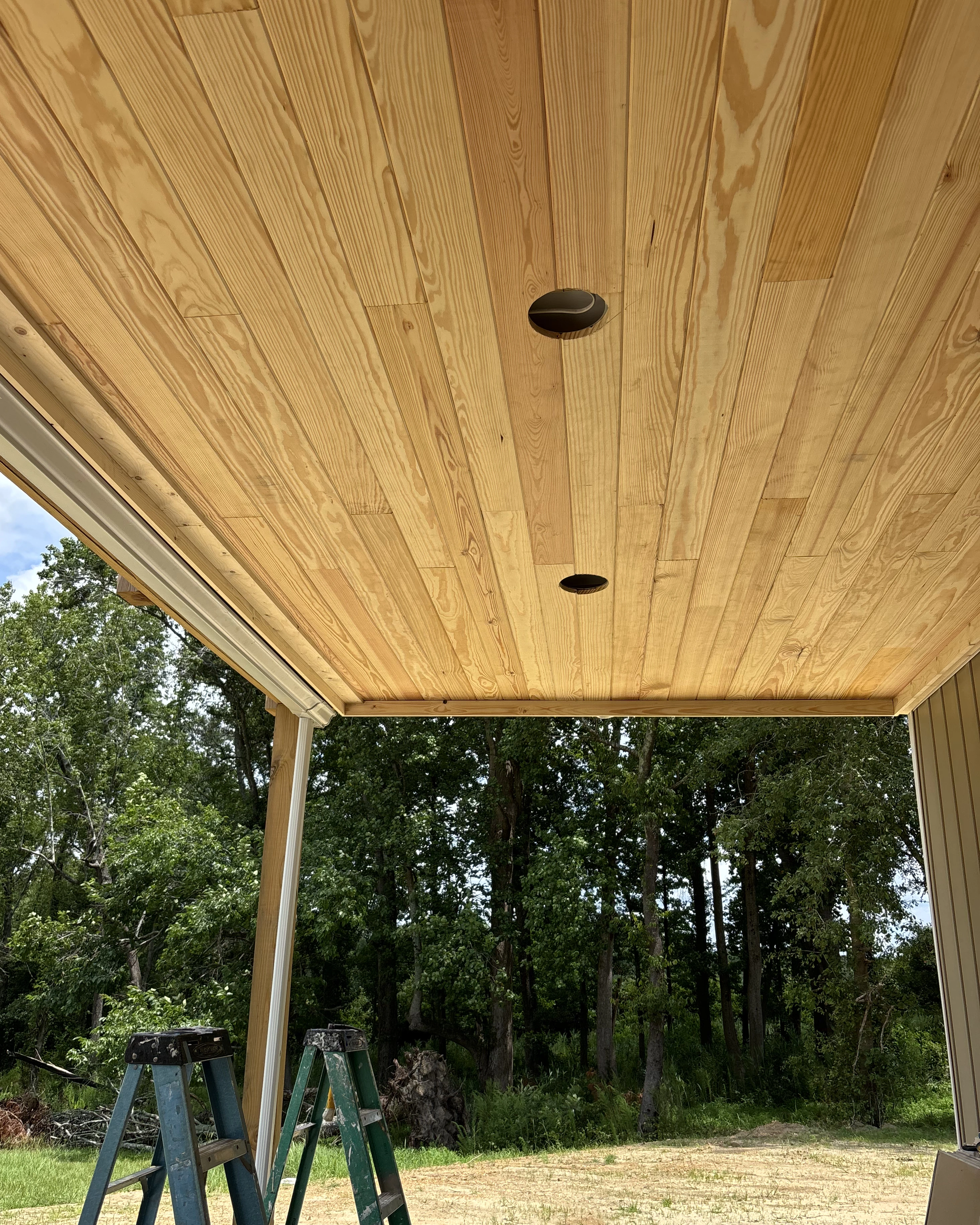 Tongue-and-groove ceiling installation showing multiple light openings.